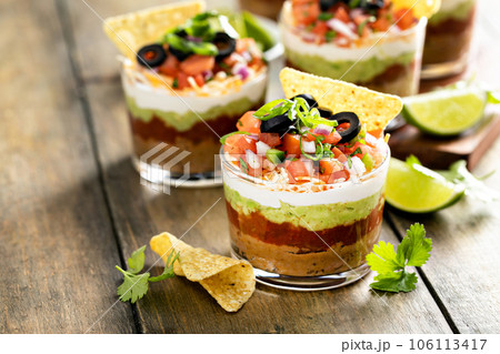 Seven layer dip in individual cups, mexican appetizer 106113417