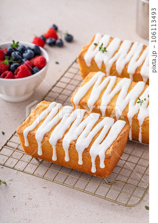 Classic pound cake with powdered sugar glaze dripping over 106113493