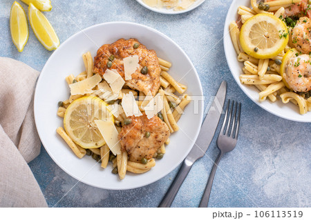 Chicken piccatta with penne pasta, lemon and capers 106113519