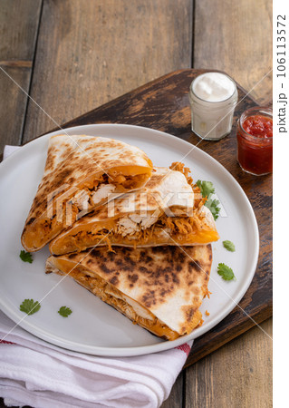 Cheddar and chicken quesadillas cut into slices on a plate 106113572