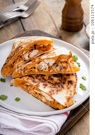 Pulled chicken and cheddar quesadillas on a plate Pulled chicken and cheddar quesadillas on a plate 106113574