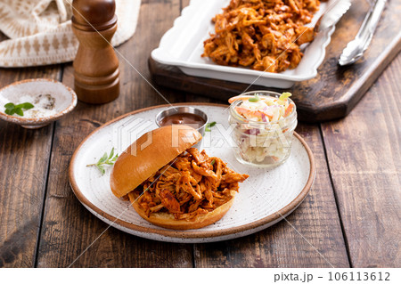 BBQ chicken sandwich on a brioche bun with coleslaw 106113612