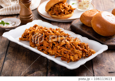 Pulled bbq chicken on a serving plate 106113613