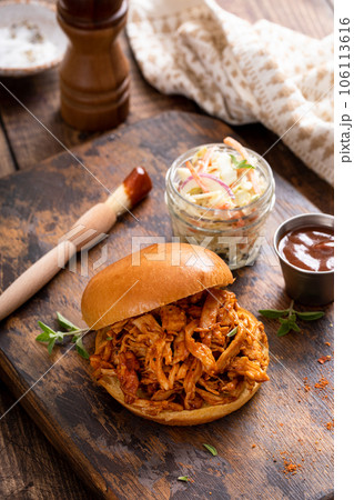 BBQ chicken sandwich on a brioche bun with coleslaw BBQ chicken sandwich on a brioche bun with coleslaw 106113616