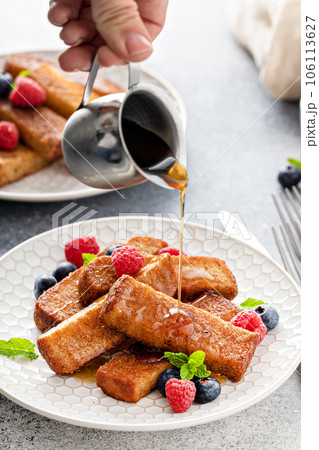 French toast sticks with maple syrup and berries French toast sticks with maple syrup and berries 106113627