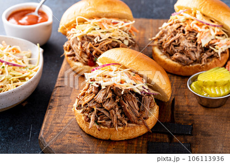 Pulled pork sandwiches with cole slaw on brioche buns Pulled pork sandwiches with cole slaw on brioche buns 106113936