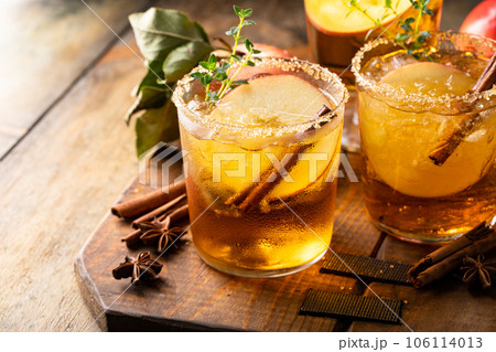 Apple cider margarita with brown sugar rim and cinnamon stick 106114013
