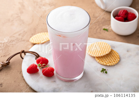 Strawberry or raspberry iced milk cocktail in a tall glass 106114135