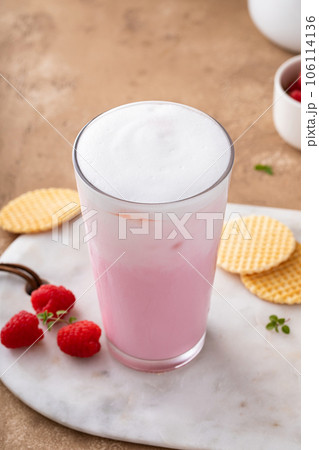 Strawberry or raspberry iced milk cocktail in a tall glass Strawberry or raspberry iced milk cocktail in a tall glass 106114136