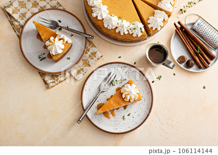 Pumpkin cheesecake with fall spices topped with whipped cream Pumpkin cheesecake with fall spices topped with whipped cream 106114144