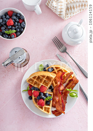 Belgian waffles with bacon and fresh berries for breakfast 106114159