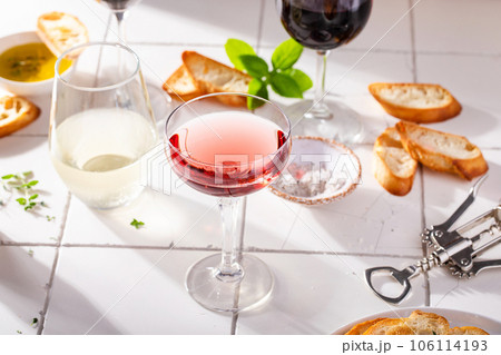 Variety of wine glasses with red, white and rose wine 106114193
