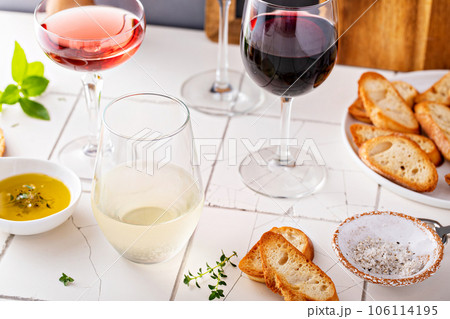 Variety of wine glasses with red, white and rose wine 106114195