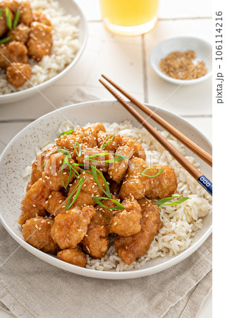 Orange chicken with green onions and sesame seeds 106114216