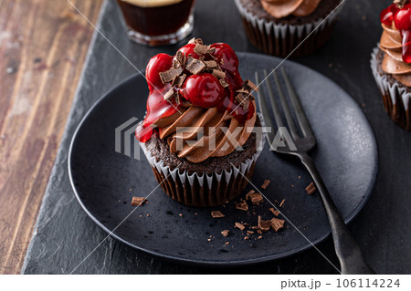 Black forest cupcake with whipped ganache and cherry topping Black forest cupcake with whipped ganache and cherry topping 106114224