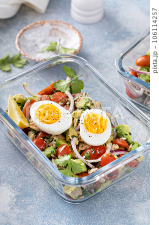 Meal prep containers with avocado tuna salad and boiled egg 106114257