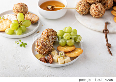 Cheese balls or truffles on a cheese board with crackers 106114280