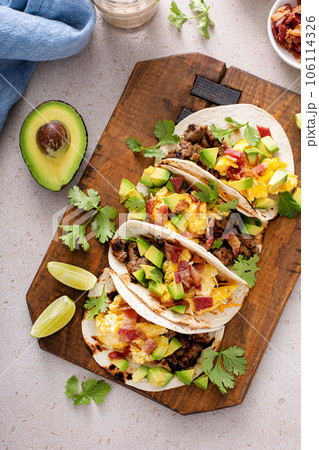 Breakfast tacos with sausage, eggs, bacon and avocado 106114326