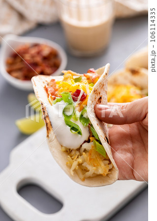 Breakfast tacos with hashbrowns, eggs and bacon Breakfast tacos with hashbrowns, eggs and bacon 106114335