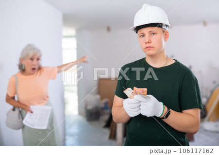 Teenager construction worker dissatisfied with small salary Teenager construction worker dissatisfied with small salary 106117162