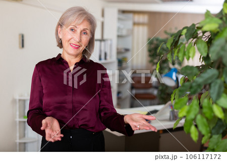 Portrait of positive elderly business woman in office Portrait of positive elderly business woman in office 106117172
