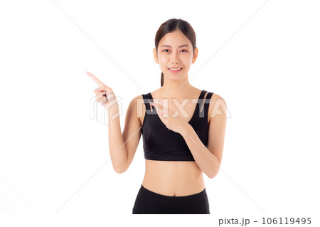 Portrait of beautiful young asian woman in sportswear smile and presenting isolated. 106119495