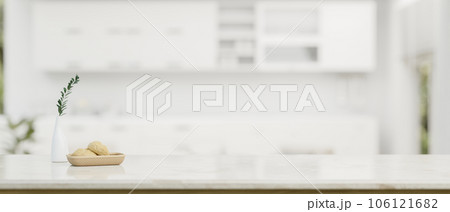Copy space for displaying your product on a white tabletop over a blurred modern white kitchen 106121682