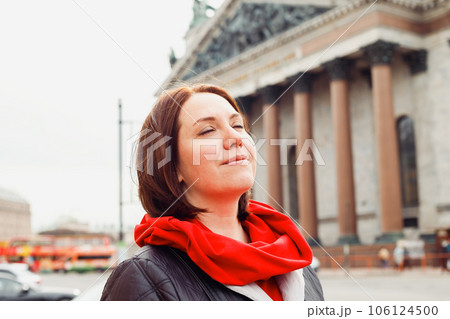caucasian female woman with closed eyes on street of historic european city. 38 years old. dreams, resting, wellbeing happy concept. close up portrait 106124500