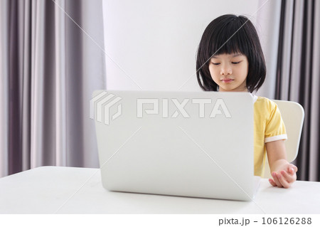 little asian girl student study online using laptop computer at home 106126288