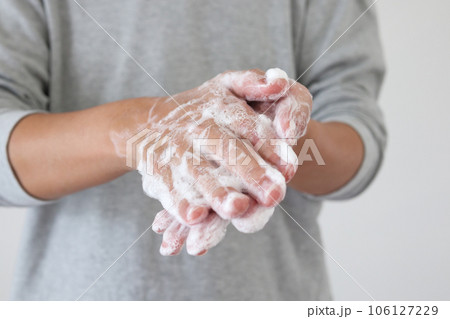Man wash hands with soap for COVID-19 corona virus prevention concept 106127229