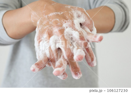 Man wash hands with soap for COVID-19 corona virus prevention concept 106127230