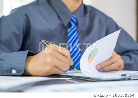 Businessmen bookkeeper hand holding pen doing account for paying tax in working office Businessmen bookkeeper hand holding pen doing account for paying tax in working office 106130354