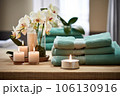 folded towels in a spa-like arrangement with candles 106130916