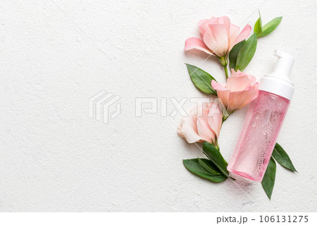 Composition with cosmetic products and beautiful roses on cement background. Copy space, flat lay Composition with cosmetic products and beautiful roses on cement background. Copy space, flat lay 106131275