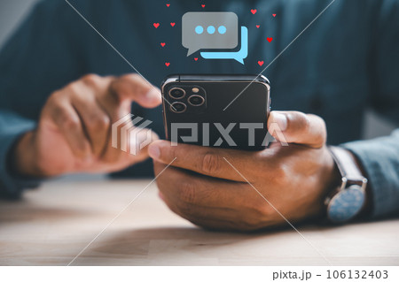 Mans hand on smartphone types, engaging in live chat and social network concepts, chat box icons emerge, symbolizing modern communication and social media marketing. Social media marketing technology Mans hand on smartphone types, engaging in live chat and social network concepts, chat box icons emerge, symbolizing modern communication and social media marketing. Social media marketing technology 106132403