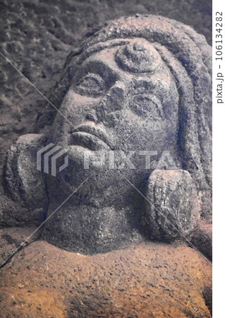 A Close Up Carved Women's Face Detail on right in the courtyard of Karla Chaitya, these Caves was constructed between 50 and 70 CE, and 120 CE, located near the Karla, Lonavala in Pune Dist. A Close Up Carved Women's Face Detail on right in the courtyard of Karla Chaitya, these Caves was constructed between 50 and 70 CE, and 120 CE, located near the Karla, Lonavala in Pune Dist. 106134282
