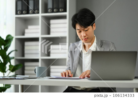 Businessman sitting at office desk working with startup project at modern office 106134333