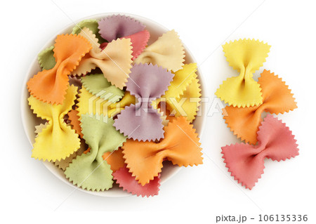 colorful farfalle pasta in ceramic bowl isolated on white background with full depth of field. Top view. Flat lay. colorful farfalle pasta in ceramic bowl isolated on white background with full depth of field. Top view. Flat lay. 106135336