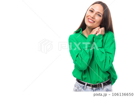 portrait of an adorable slim cute brown-eyed brunette woman dressed in a green shirt smiling on 106136650