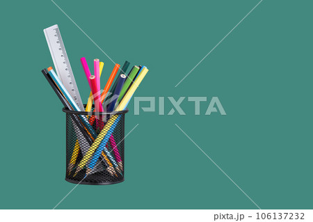 Desk organizer with colourful pencils on green background. Pencil Holder with school supplies. Back to school concept. 106137232