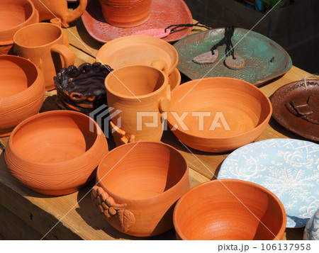 Ceramic tableware with natural patterns painted, close-up. Objects of ethnic crafts, small business, handmade. Ceramic tableware with natural patterns painted, close-up. Objects of ethnic crafts, small business, handmade. 106137958