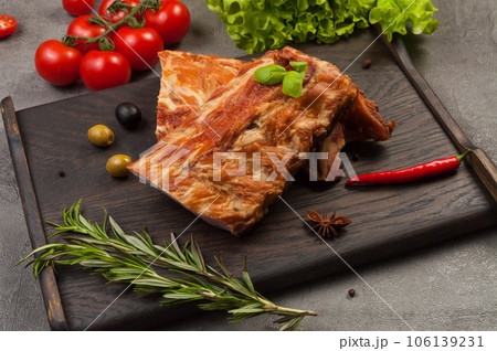 pork ribs boiled and smoked on a dark wooden board pork ribs boiled and smoked on a dark wooden board 106139231