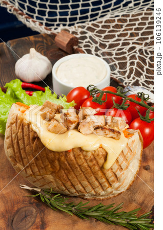 shawarma with lots of cheese and fried chicken with tomatoes and cheese sauce shawarma with lots of cheese and fried chicken with tomatoes and cheese sauce 106139246