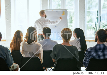 Male speaker giving talk at business meeting. Audience in conference hall. Business and entrepreneurship symposium. Male speaker giving talk at business meeting. Audience in conference hall. Business and entrepreneurship symposium. 106141311
