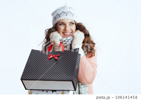 smiling woman in sweater, mittens, hat and scarf on smiling woman in sweater, mittens, hat and scarf on 106141458