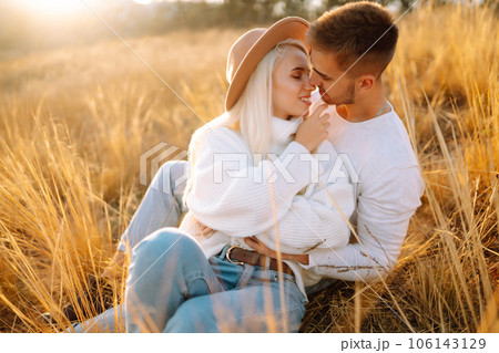 Young couple having fun walking and hugging n the park. Autumn weather. Relaxation, youth. Young couple having fun walking and hugging n the park. Autumn weather. Relaxation, youth. 106143129