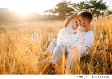 Young couple having fun walking and hugging n the park. Autumn weather. Relaxation, youth. Young couple having fun walking and hugging n the park. Autumn weather. Relaxation, youth. 106143130