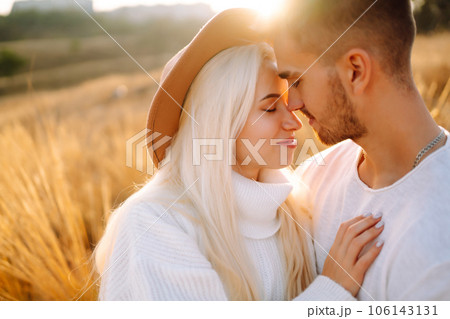 Young couple having fun walking and hugging n the park. Autumn weather. Relaxation, youth. Young couple having fun walking and hugging n the park. Autumn weather. Relaxation, youth. 106143131