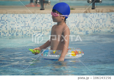A kid swim in the pool. A kid swim in the pool. 106143156