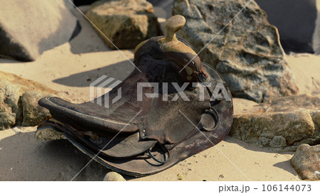 very old horse saddle on sand beach very old horse saddle on sand beach 106144073